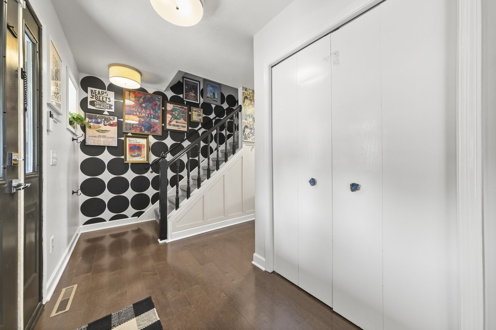 Stairway with patterned wallpaper and closets