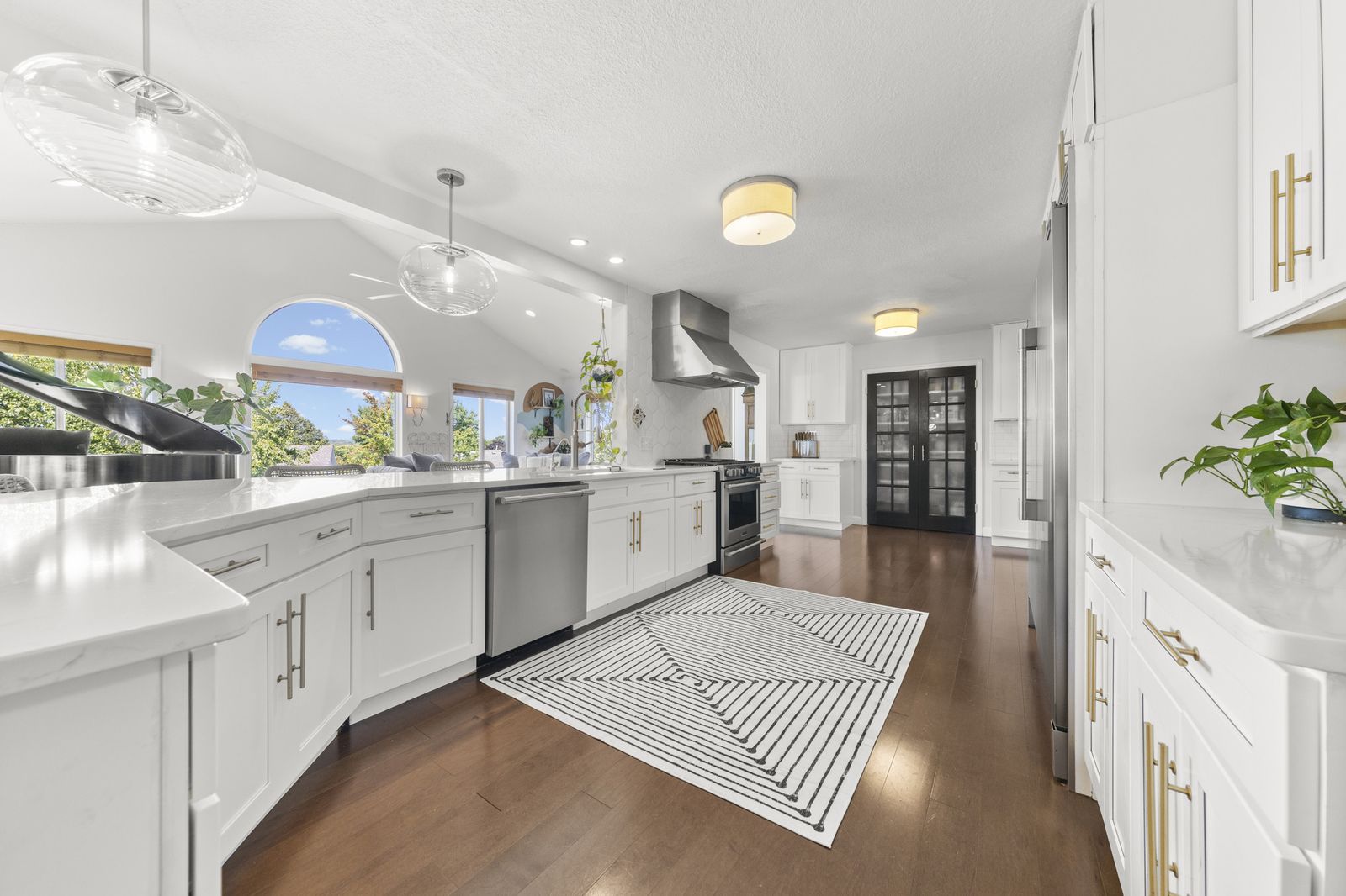 Kitchen with white cabinetry and striped runner rug