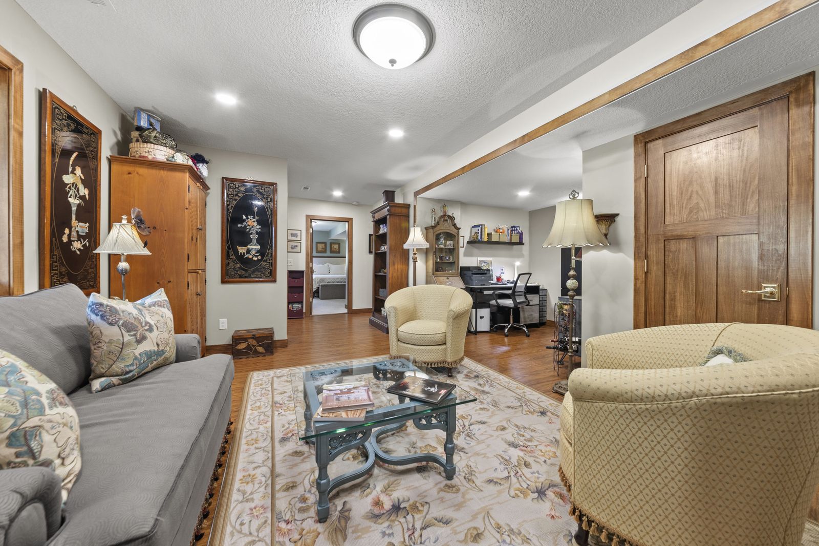 Living room, wide view with wood floors and rug