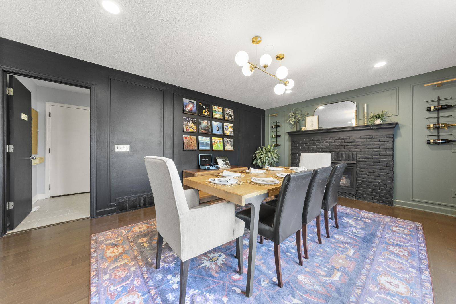Dining area with fireplace and dark accent wall