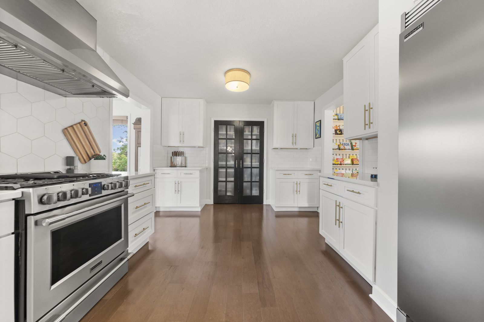 Kitchen view with dark French doors leading outside