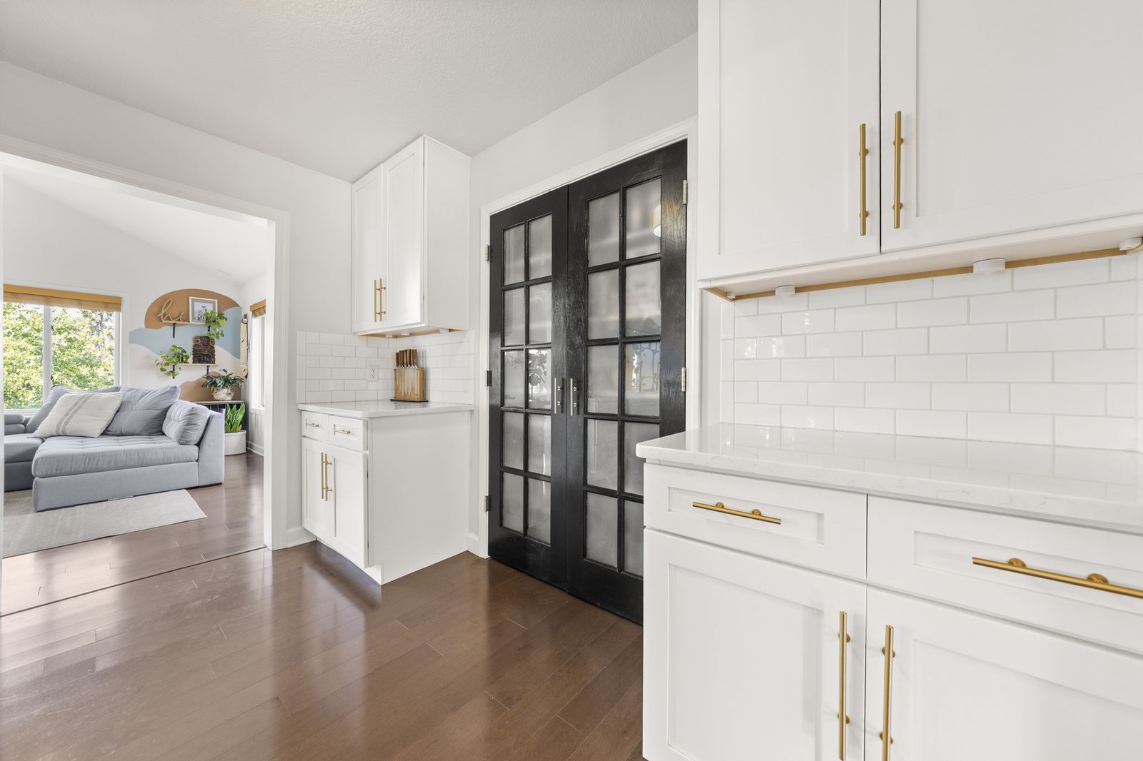 Hallway with built-in shelving and subway tile accents