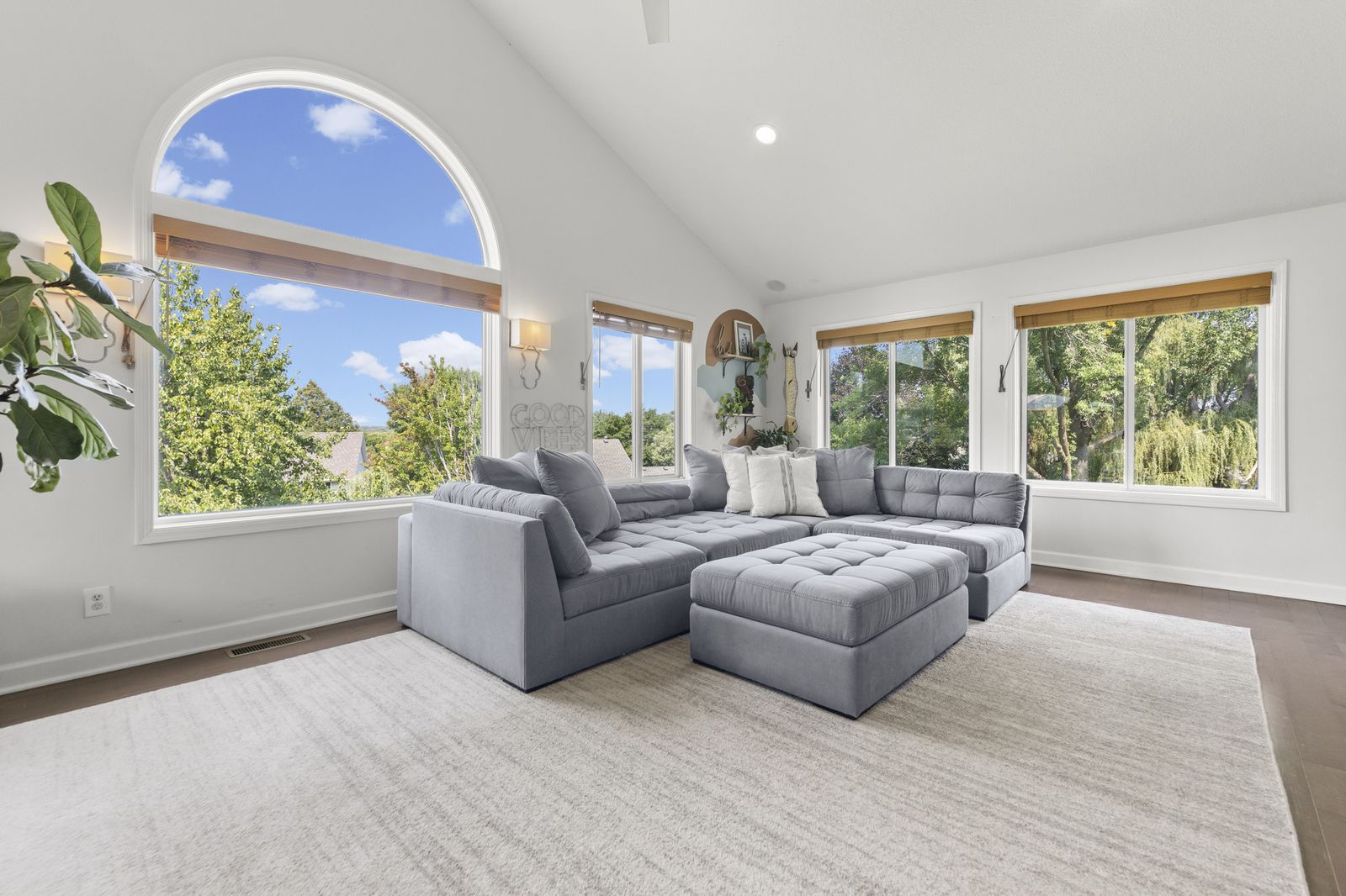 Living room with arched window and gray sectional sofa
