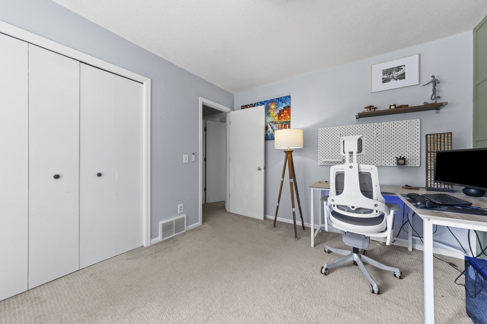 Home office with closets and desk setup