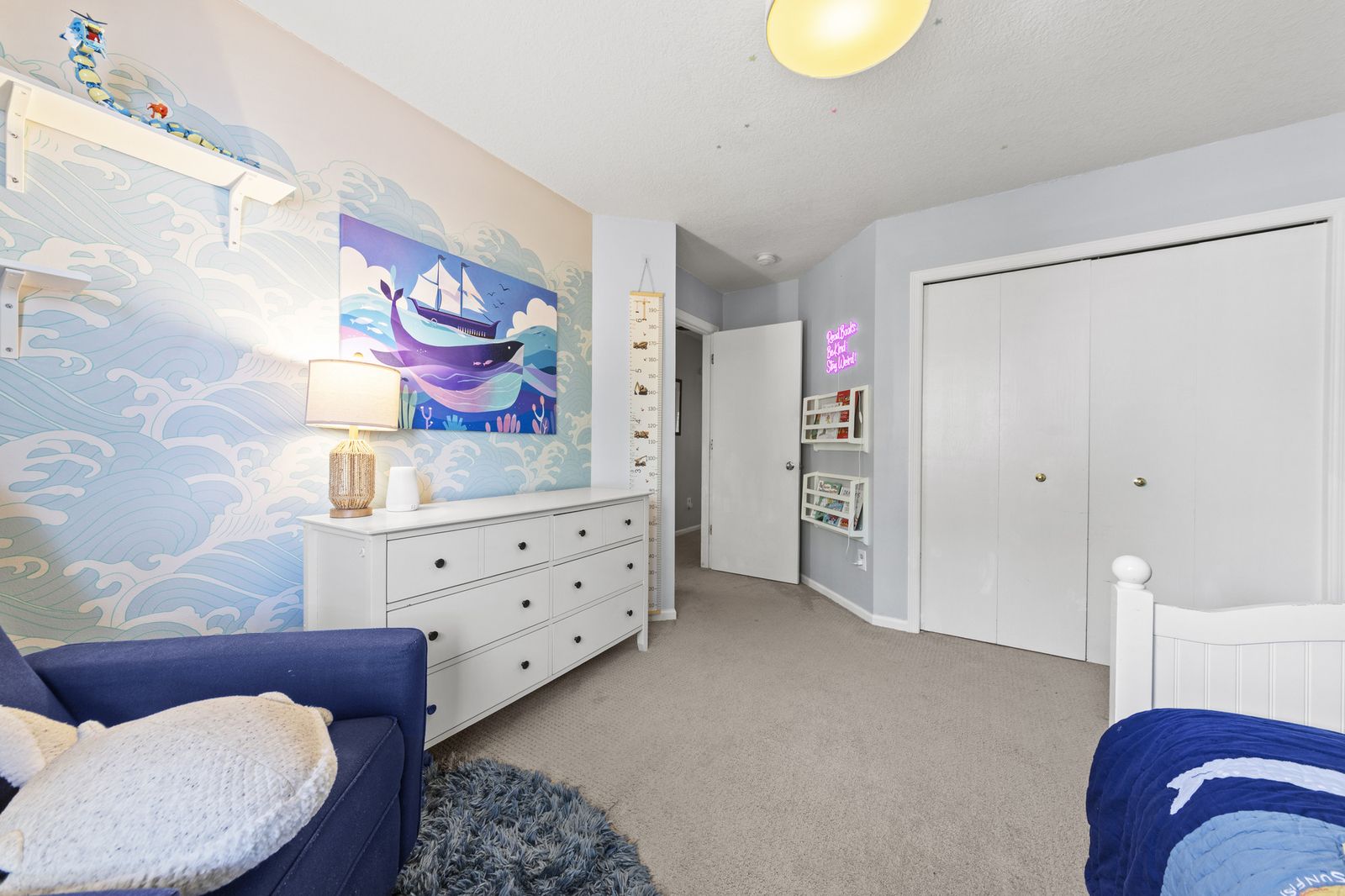 Bedroom with nautical mural and dresser