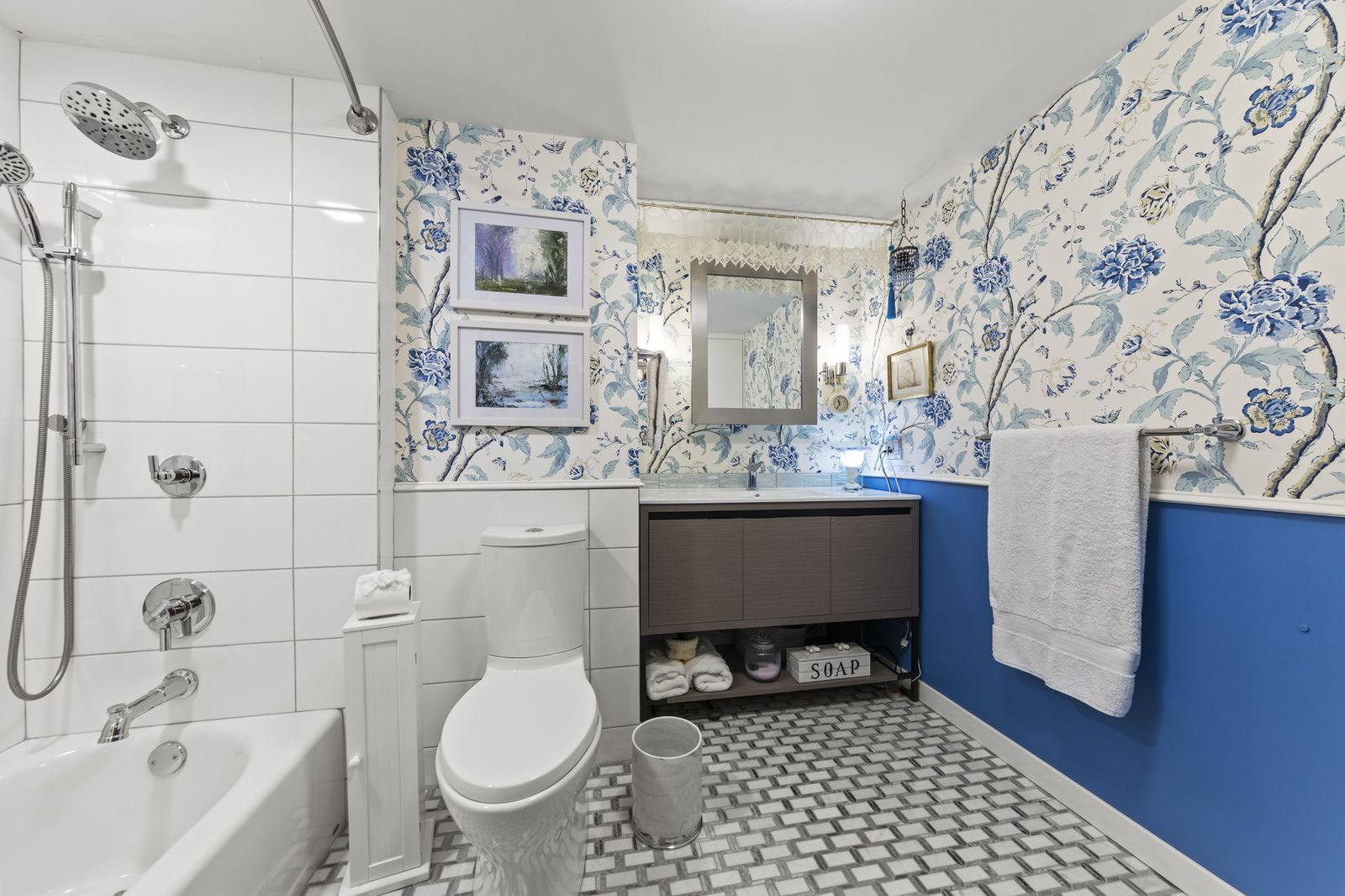 Bathroom with floral wallpaper and tub shower combo