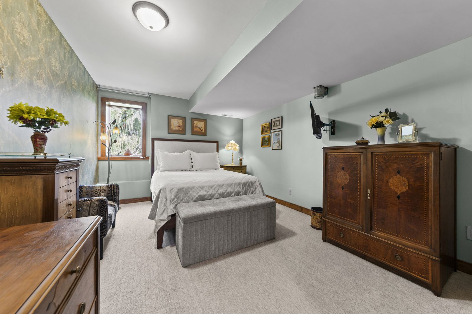 Bedroom with dark wood furniture and floral wallpaper