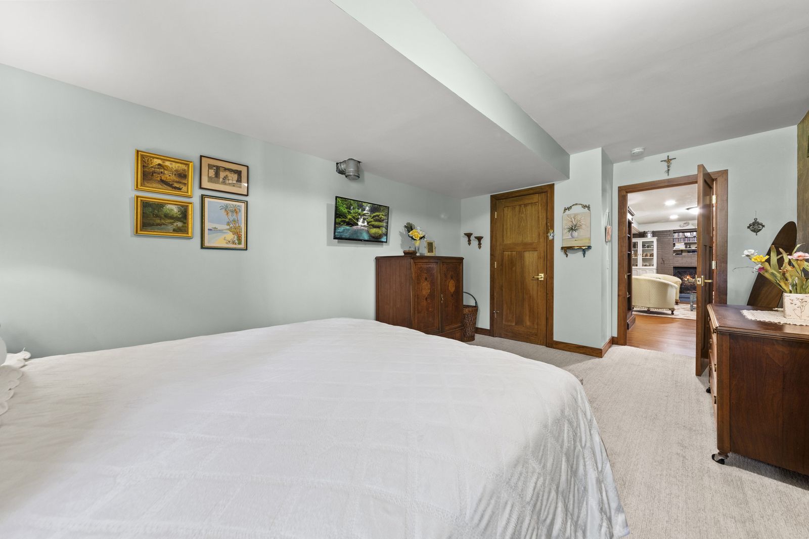 Bedroom with wallpaper and adjoining room view