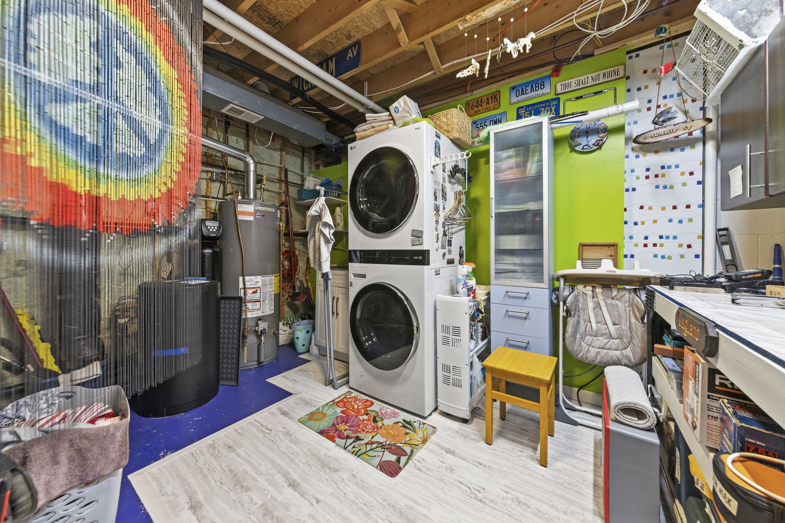 Basement utility area with laundry machines and storage
