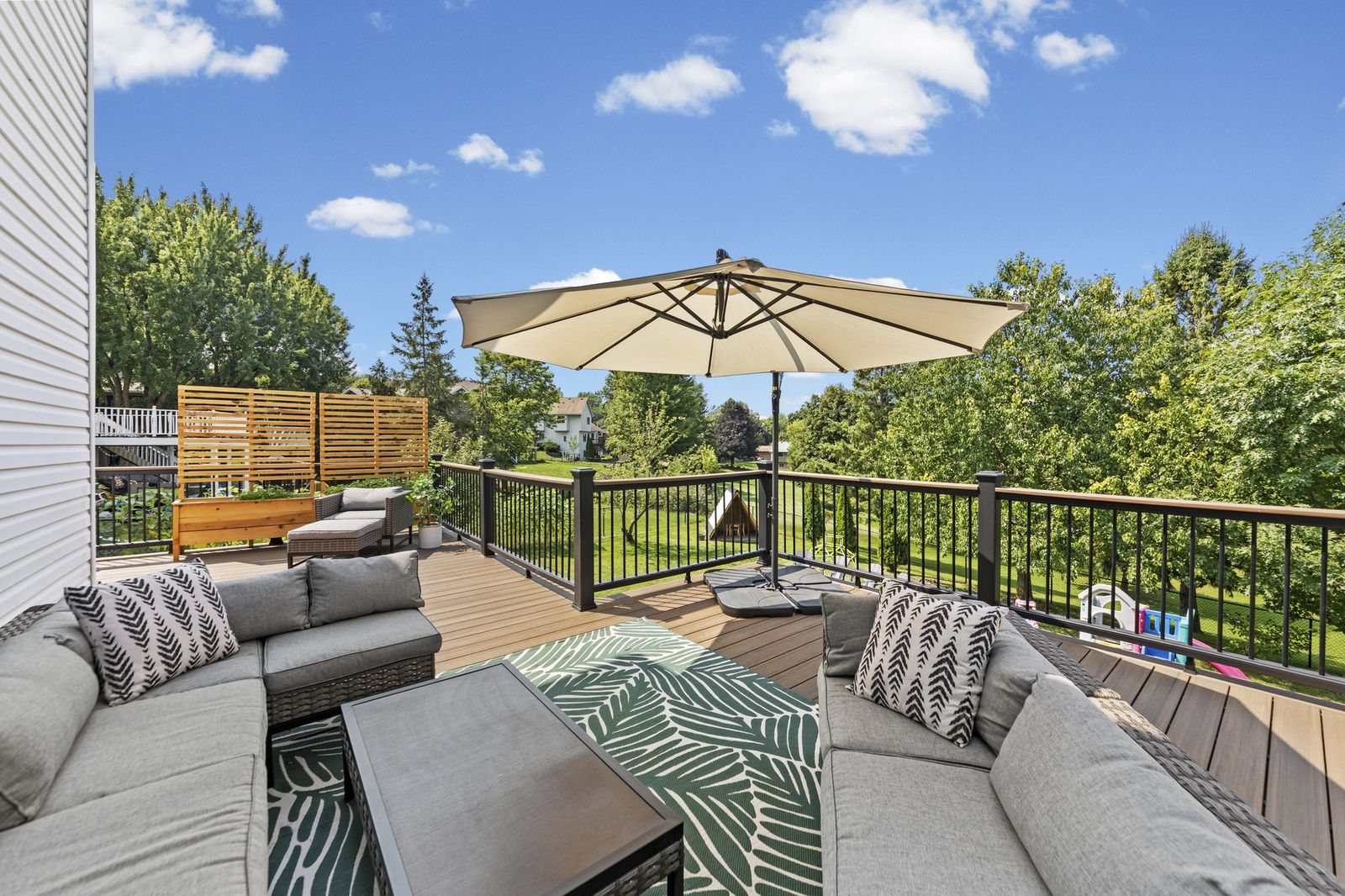 Deck with sectional seating and umbrella
