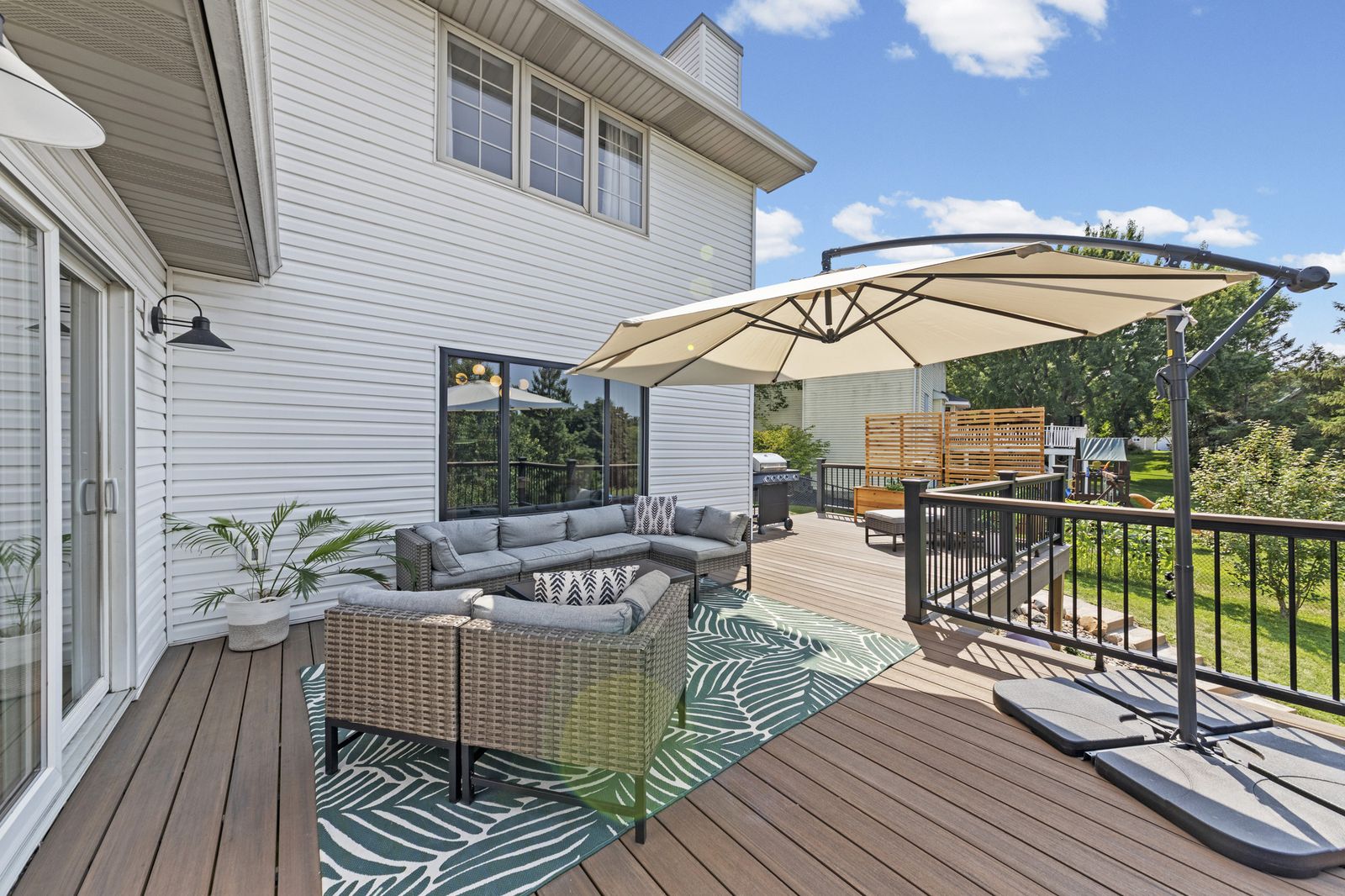 Rear patio with sectional seating and umbrella