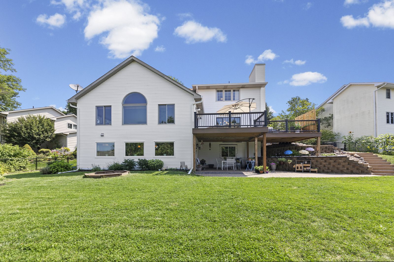 Rear exterior view of house with deck and patio