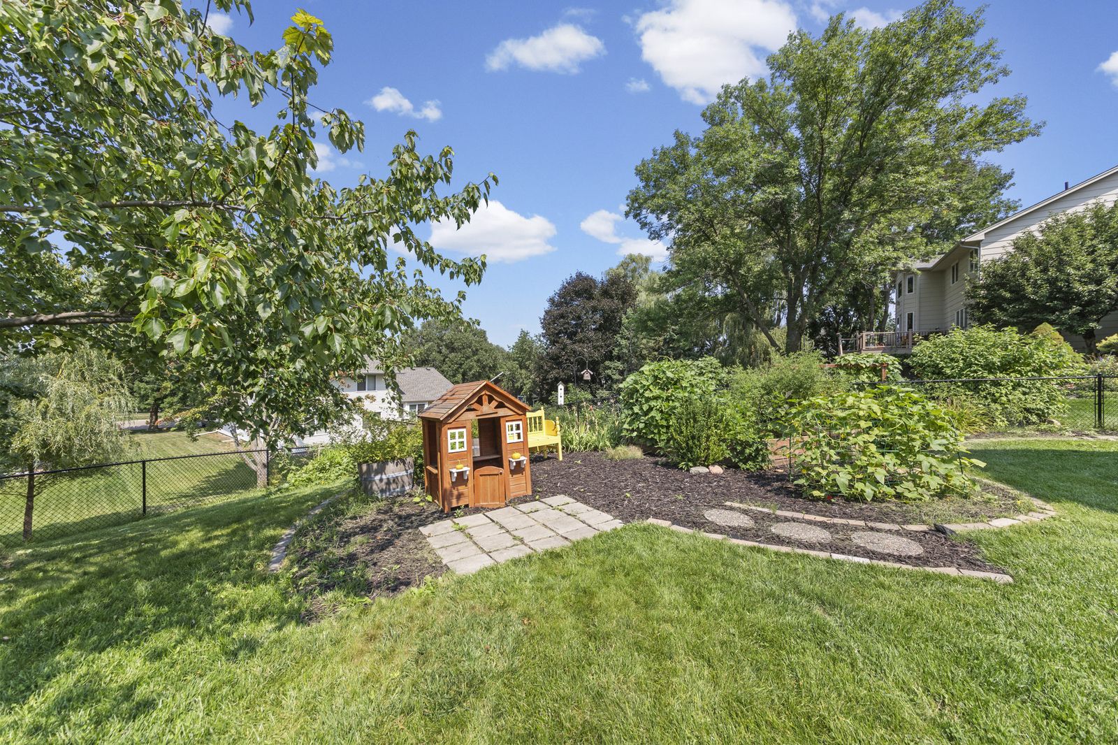 Backyard with playhouse and garden path