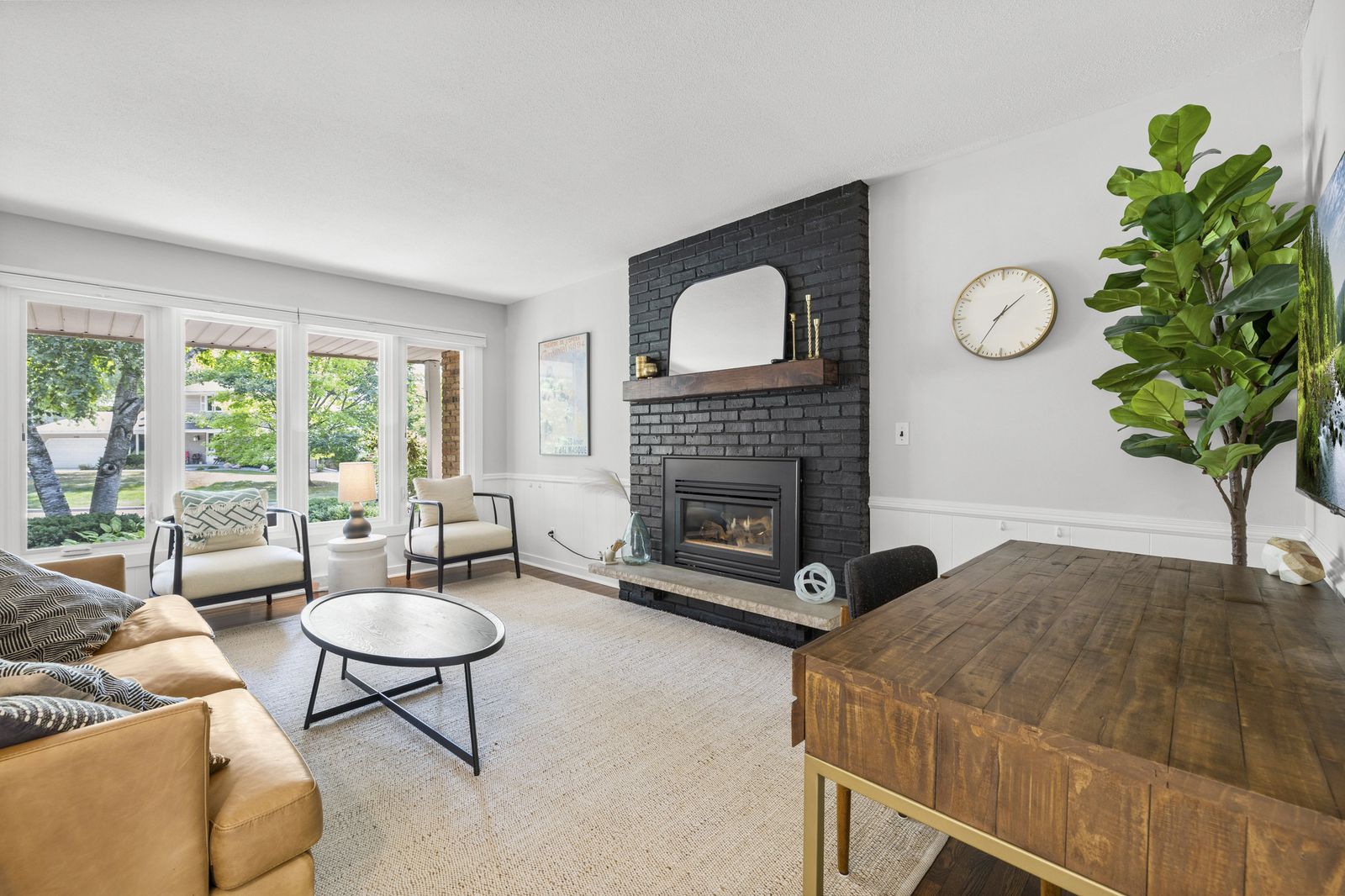 Living room with black brick fireplace and sectional sofa
