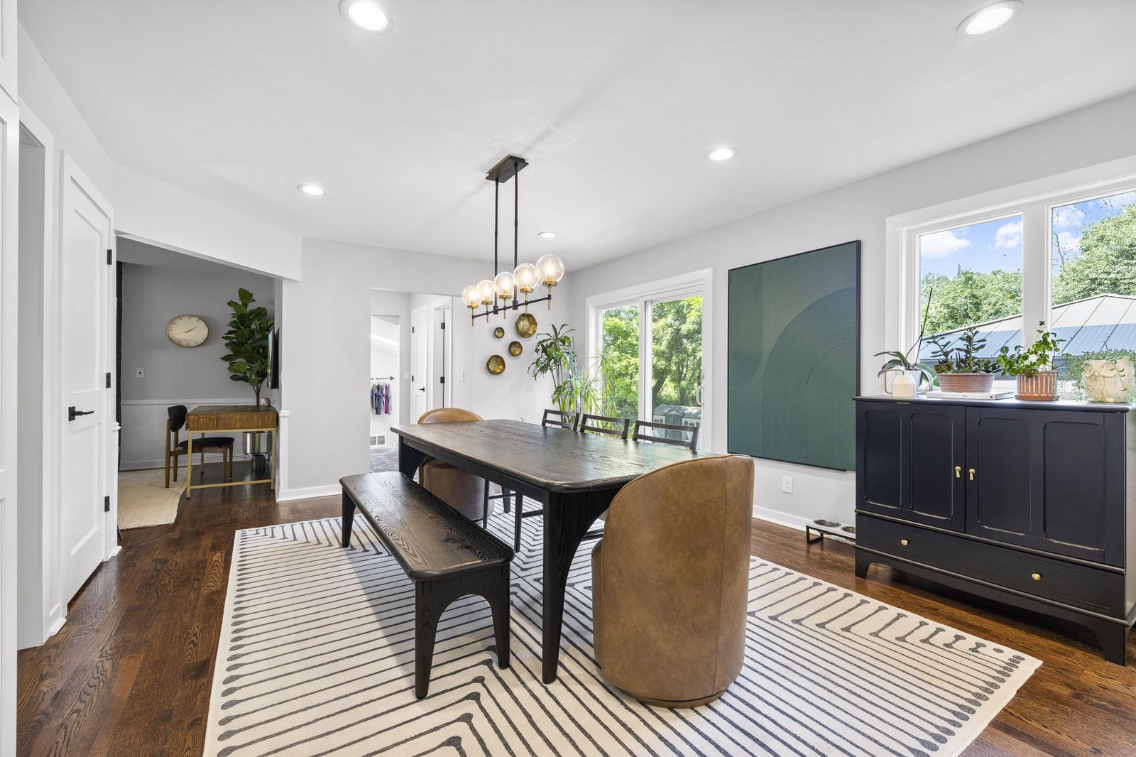 Dining area with striped rug and pendant chandelier