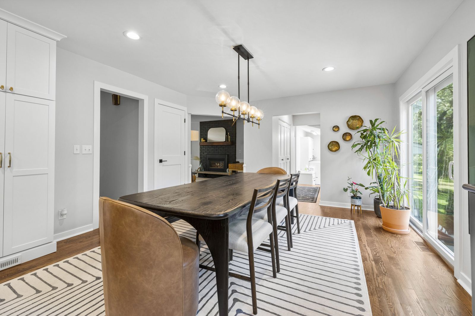 Dining area with wood beam accent and windows