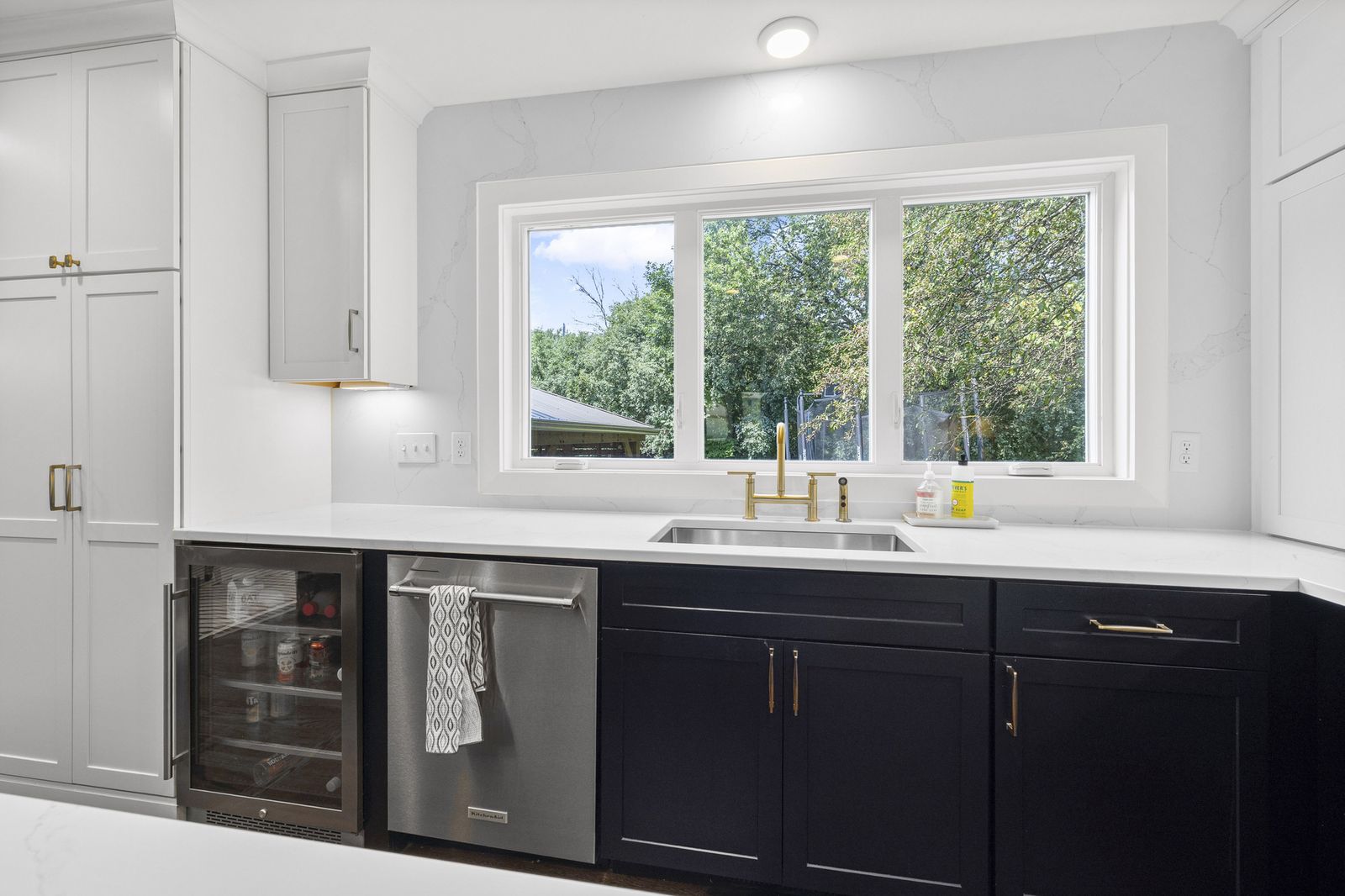Kitchen sink area with window view of yard