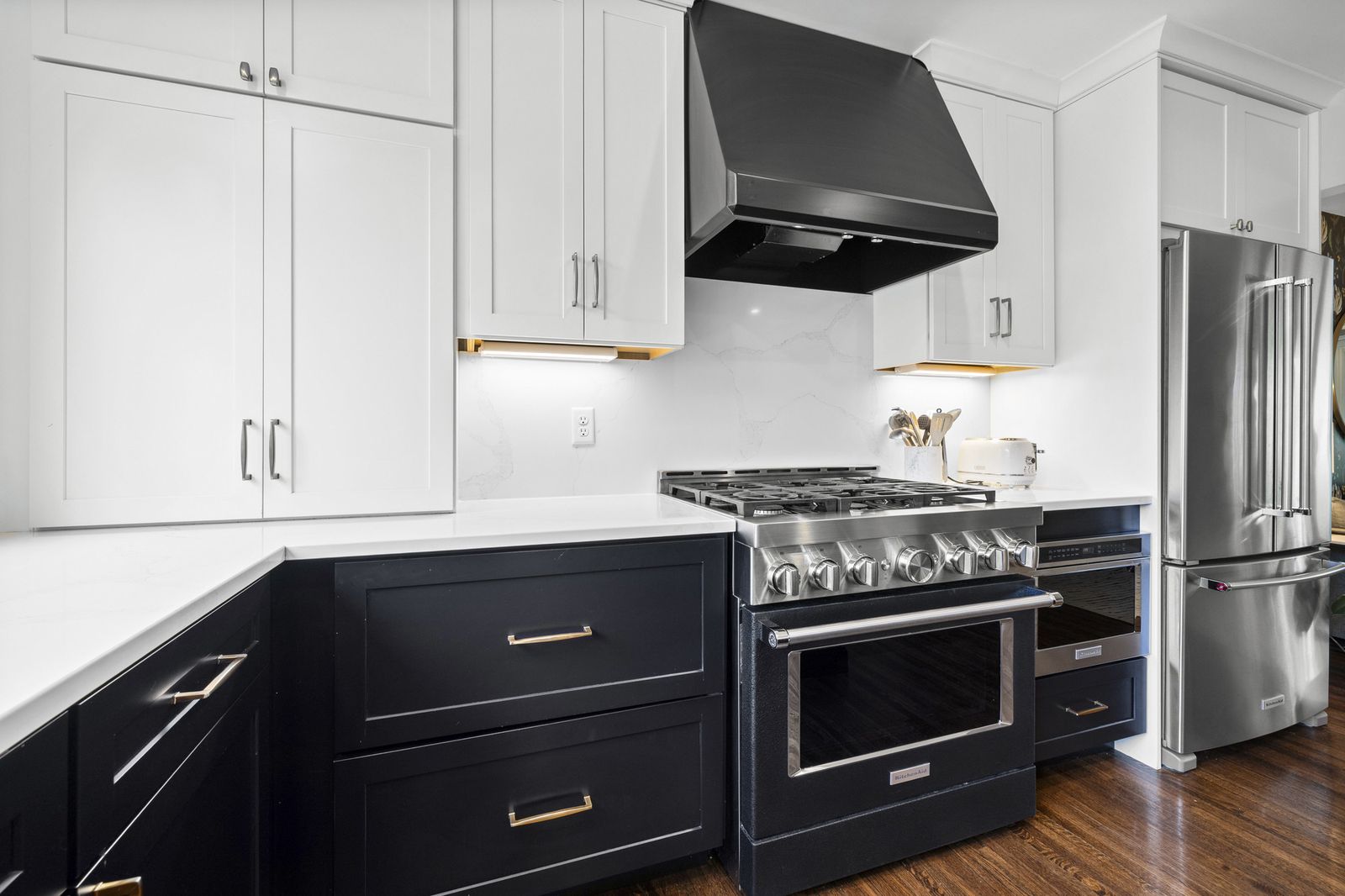 Kitchen range with black hood and cabinetry