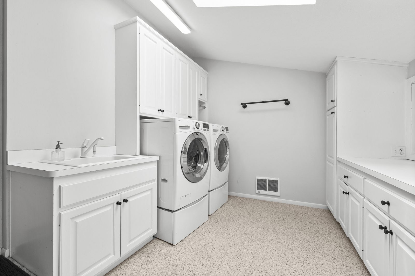Laundry room with washer, dryer, and sink