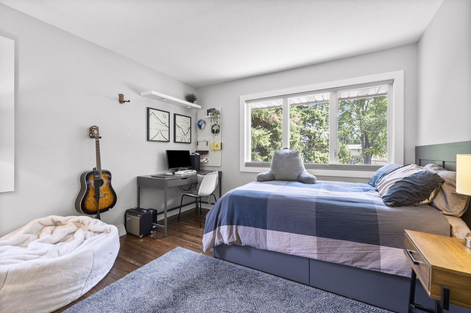 Bedroom with desk, guitar, and bean bag chair