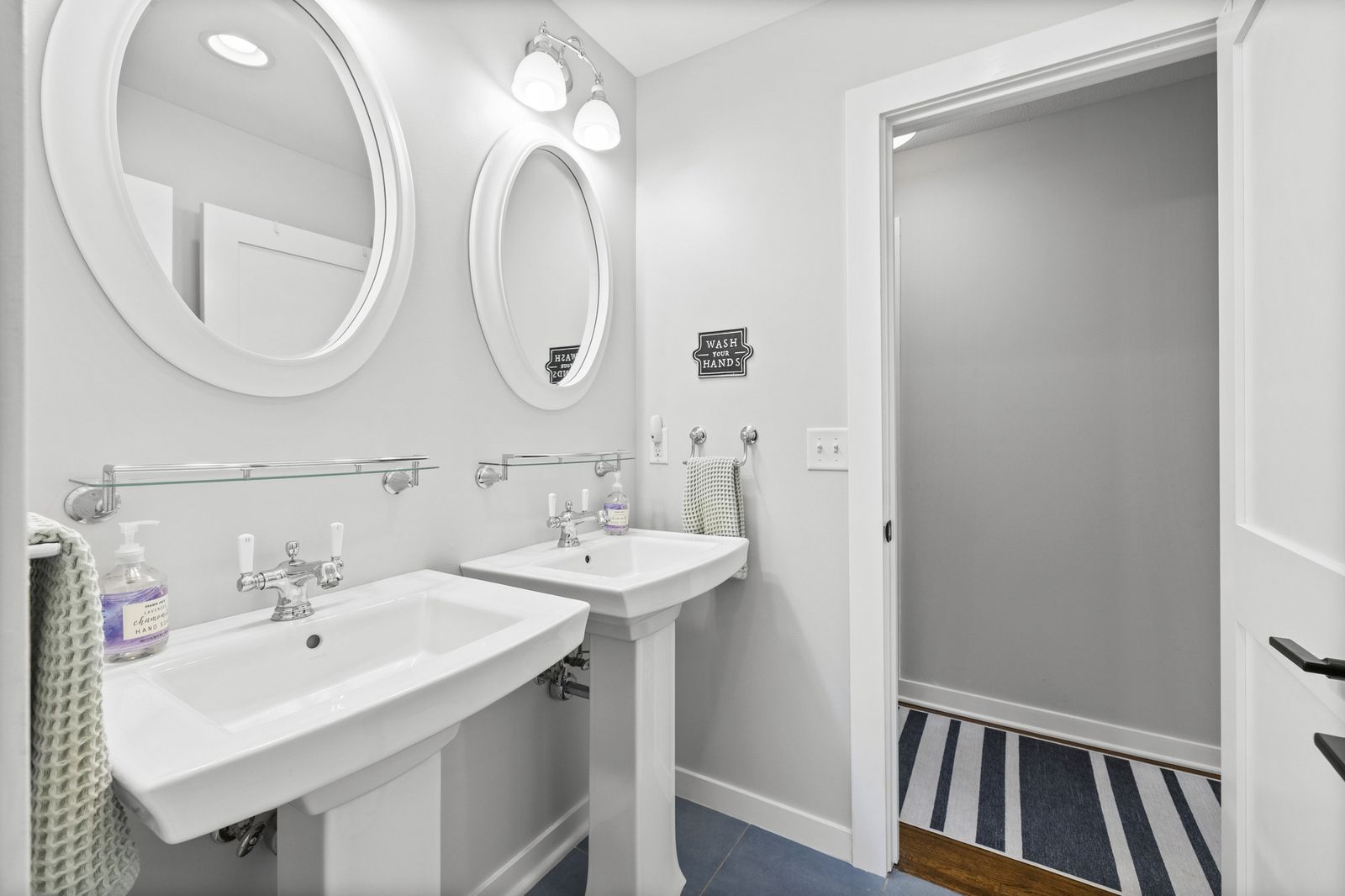 Bathroom with double pedestal sinks, alternate view