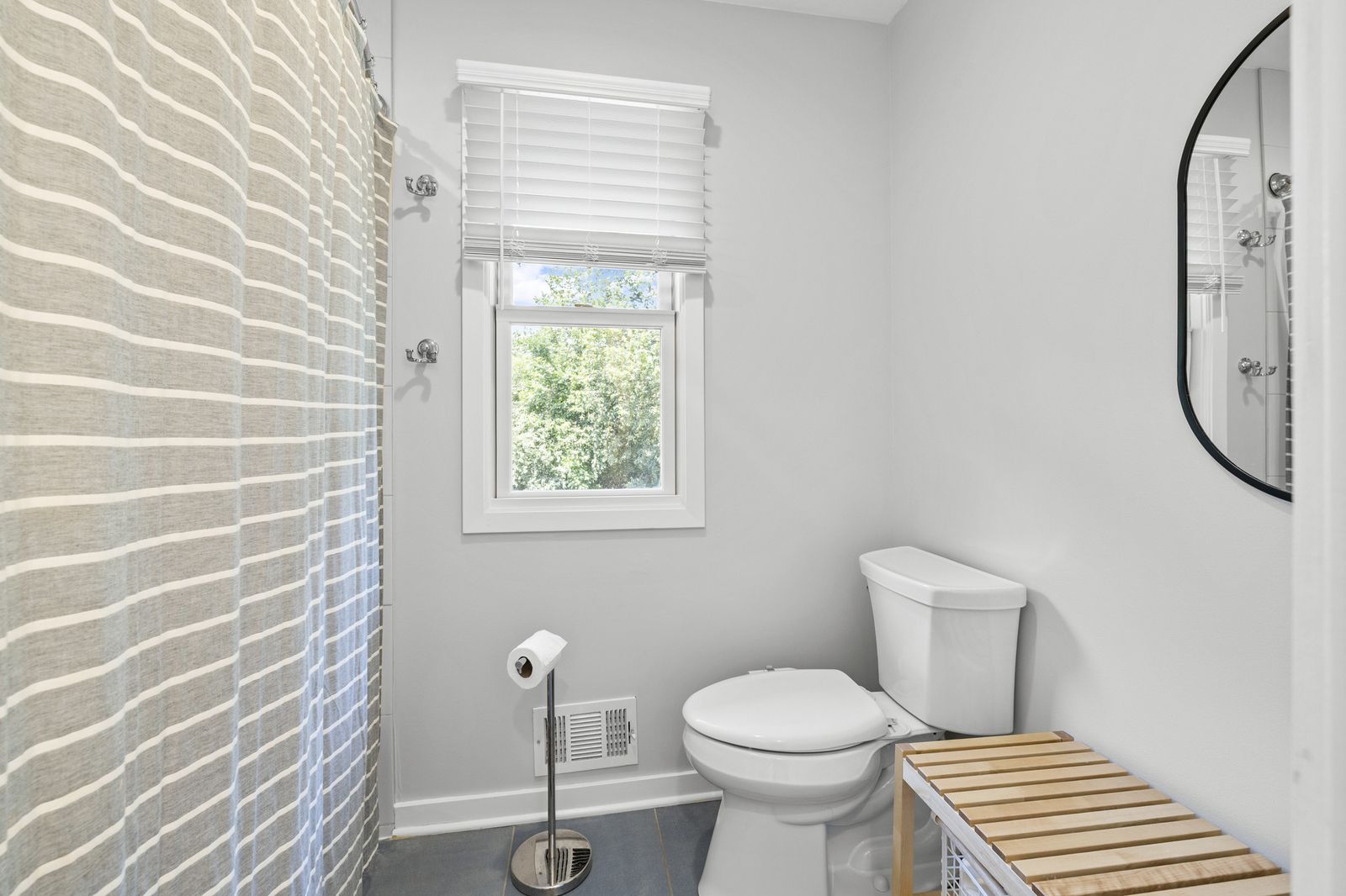Bathroom with toilet and brick accent wall