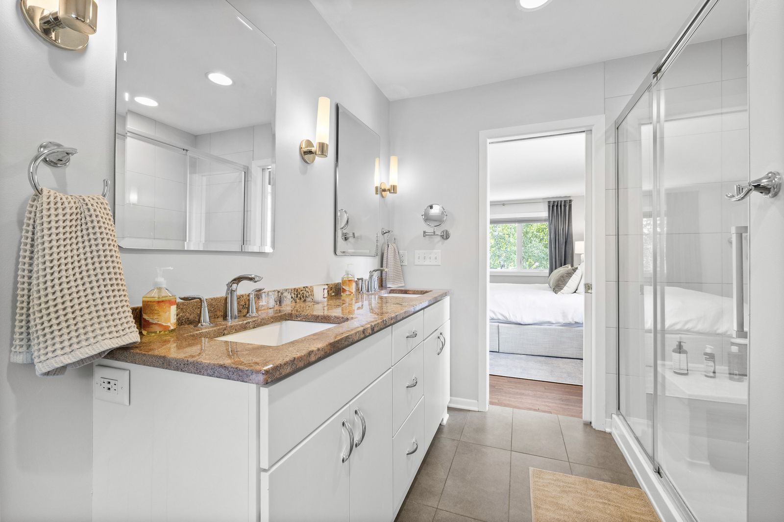 Bathroom with dual vanity and glass shower, alternate view