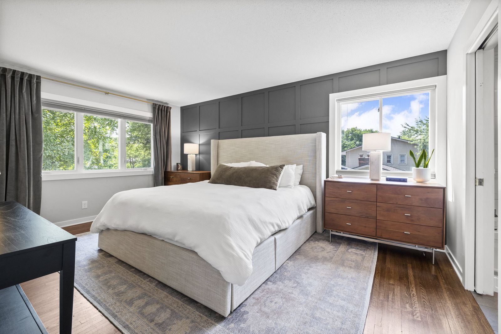 Bedroom with upholstered headboard and dresser