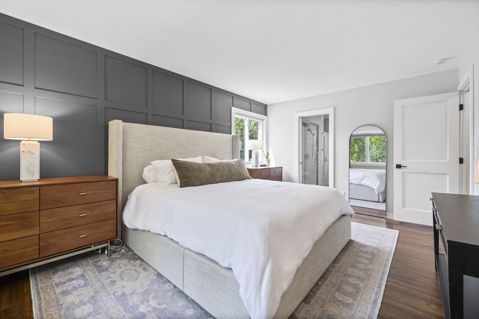 Bedroom with dark accent wall and dresser