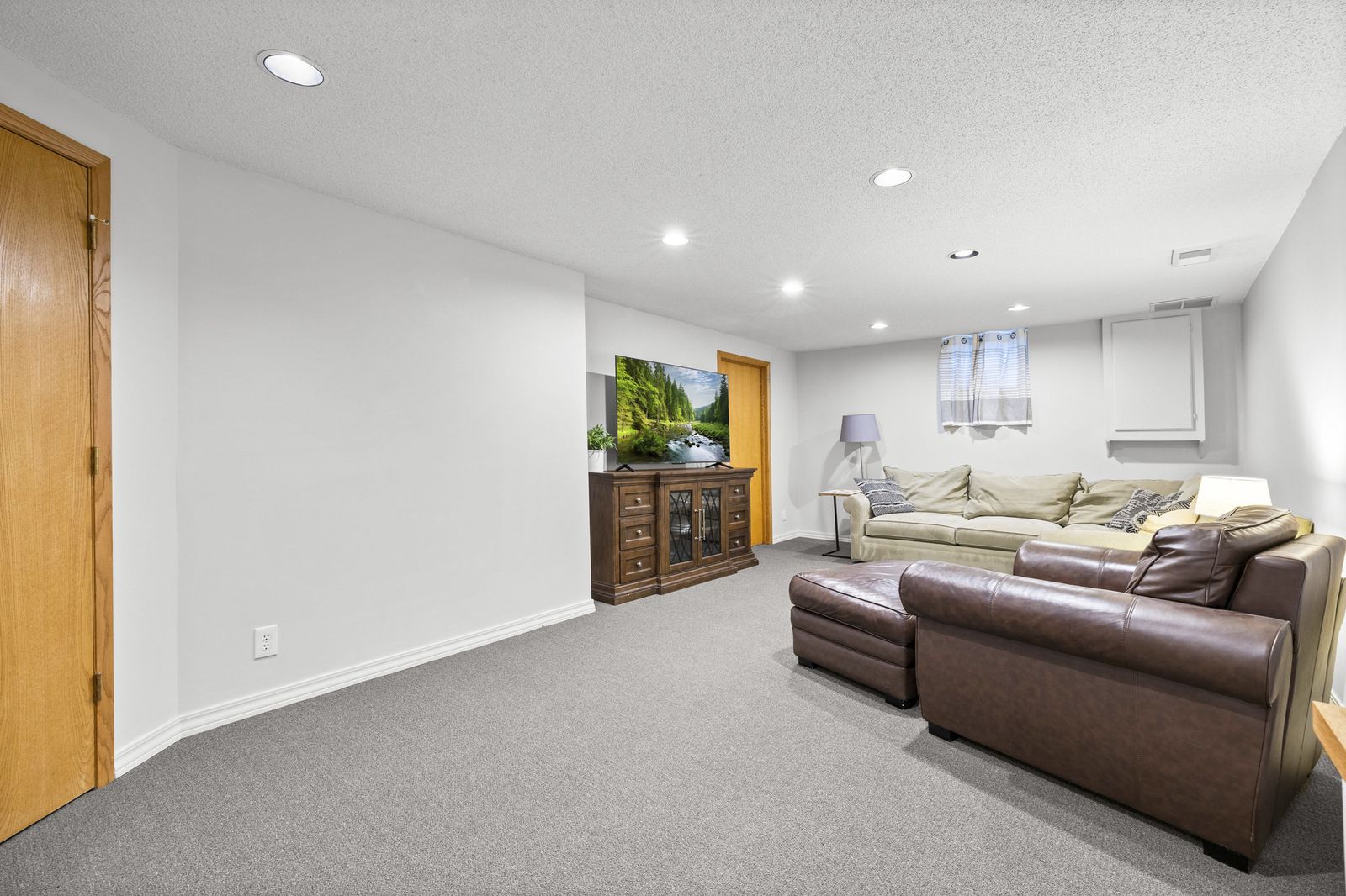 Lower level living room with sectional and leather furniture