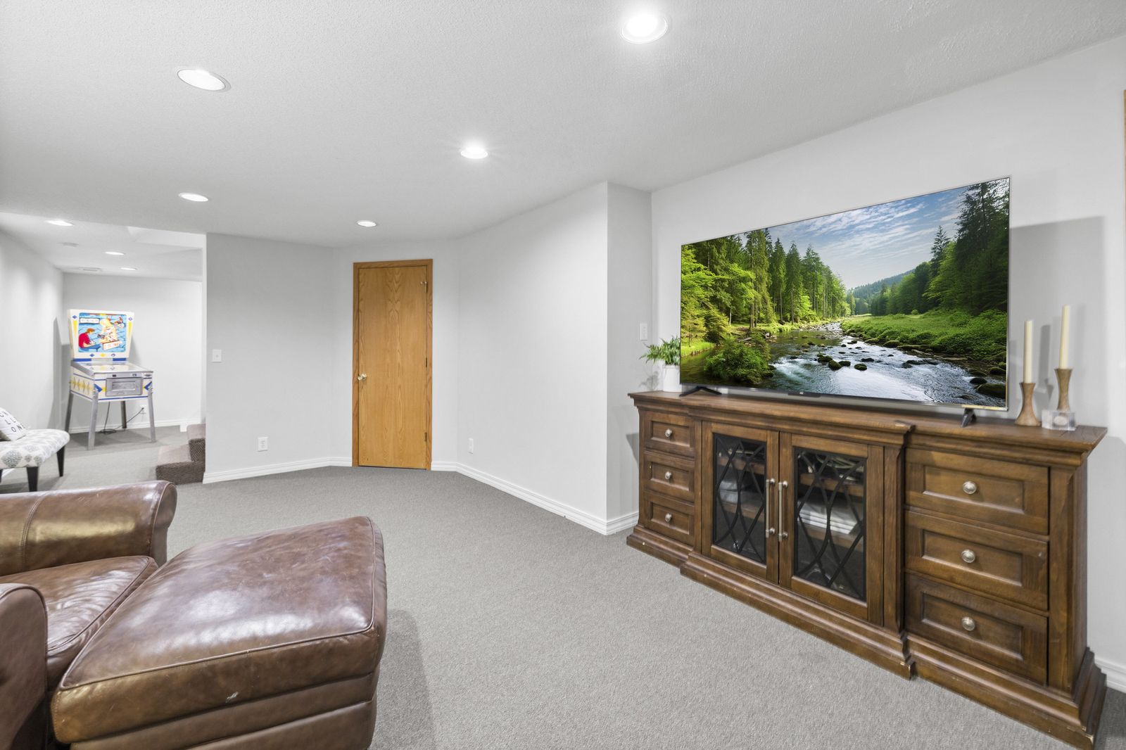 Lower level room with TV cabinet and leather chair