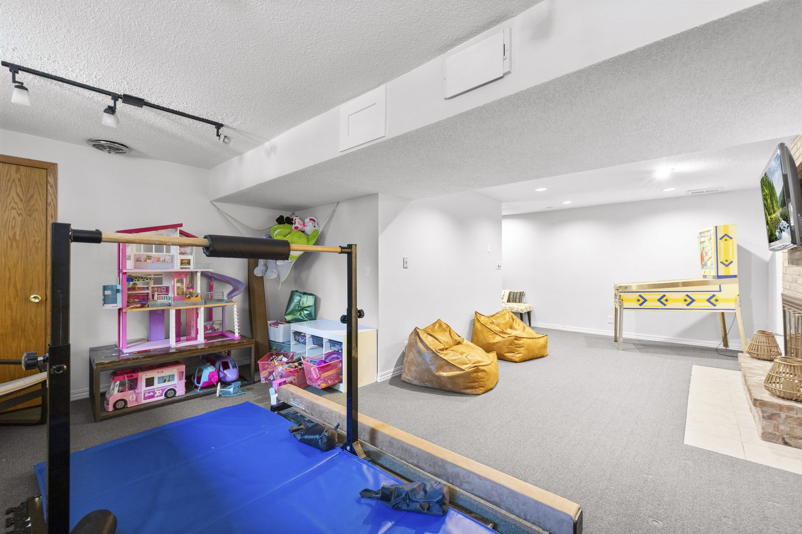 Lower level playroom with toys and exercise mats