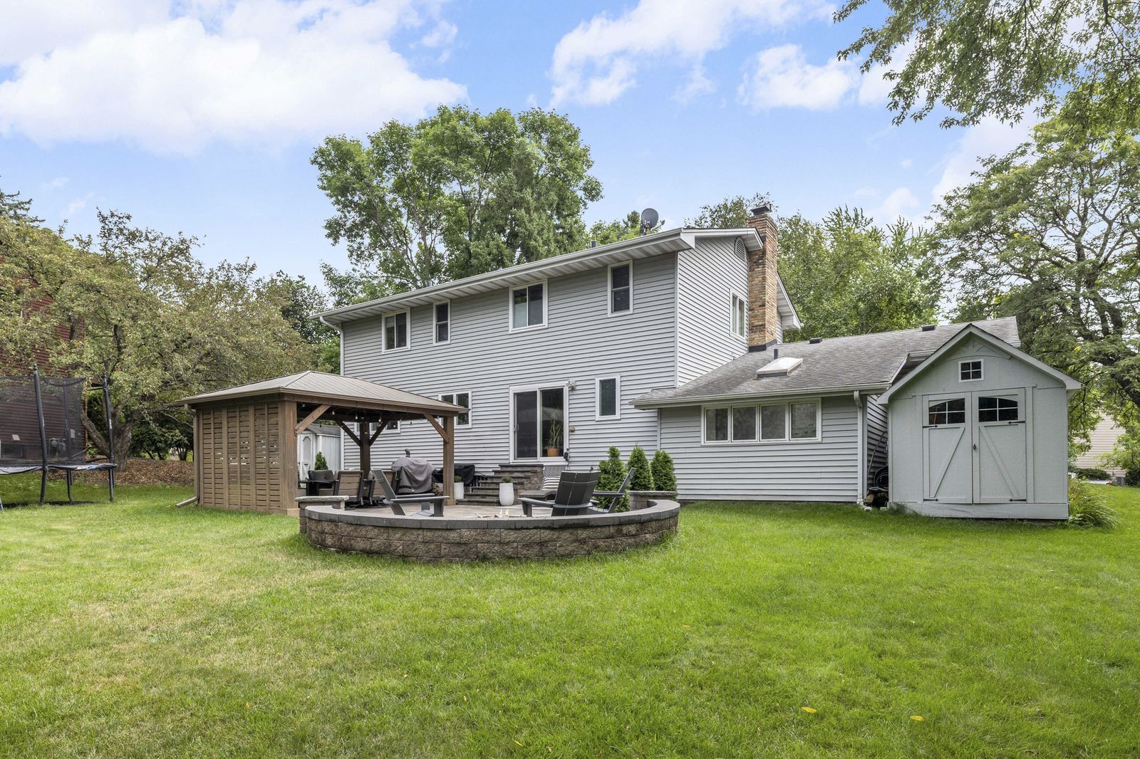 Rear exterior of house with gazebo and storage shed