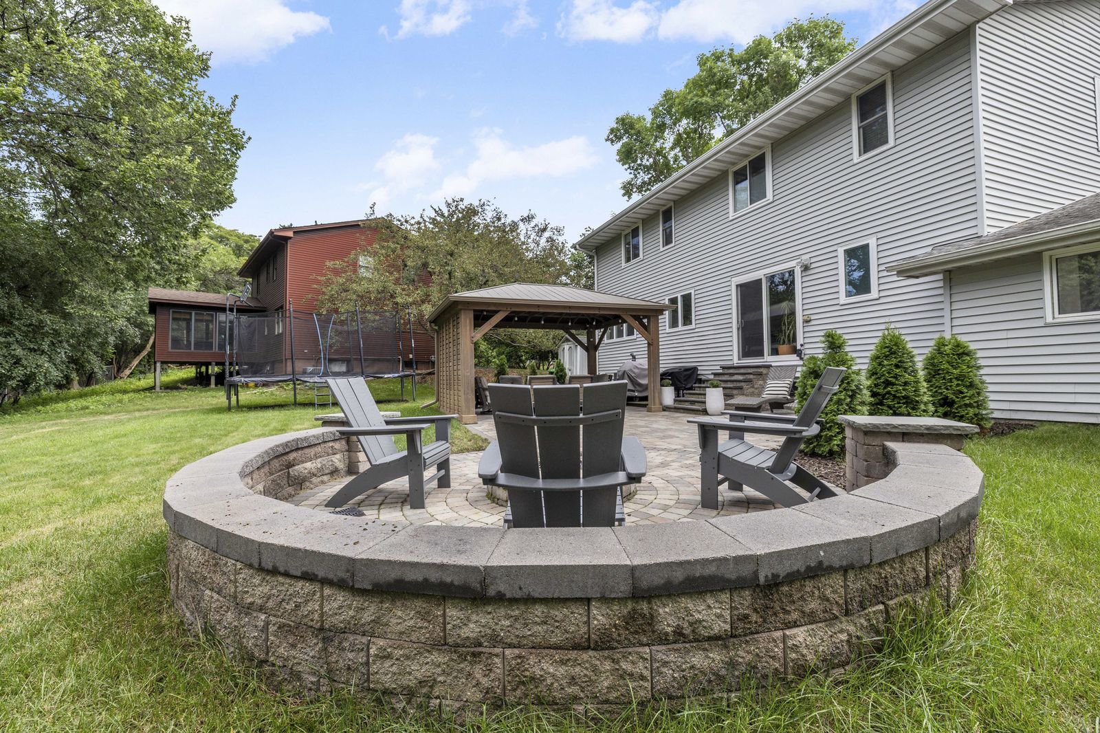 Backyard fire pit with stone seating wall