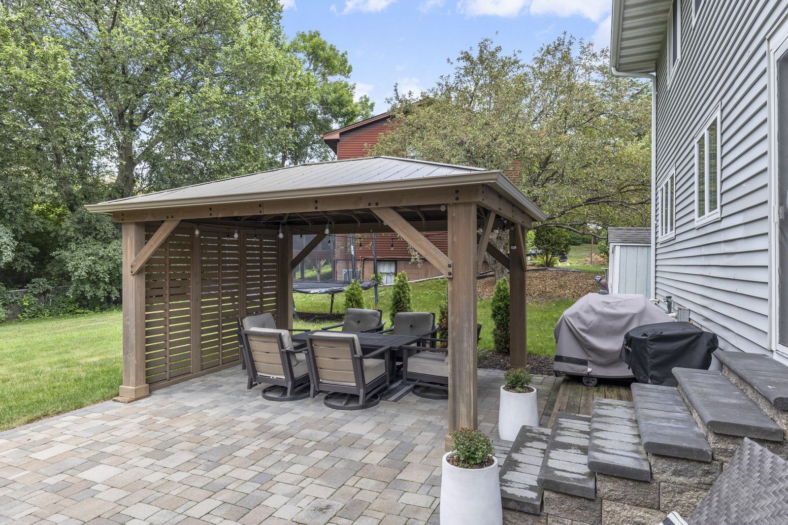 Backyard patio with pergola and outdoor dining set