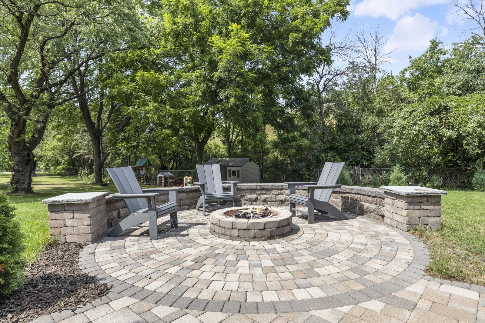 Backyard patio with fire pit and paver stones