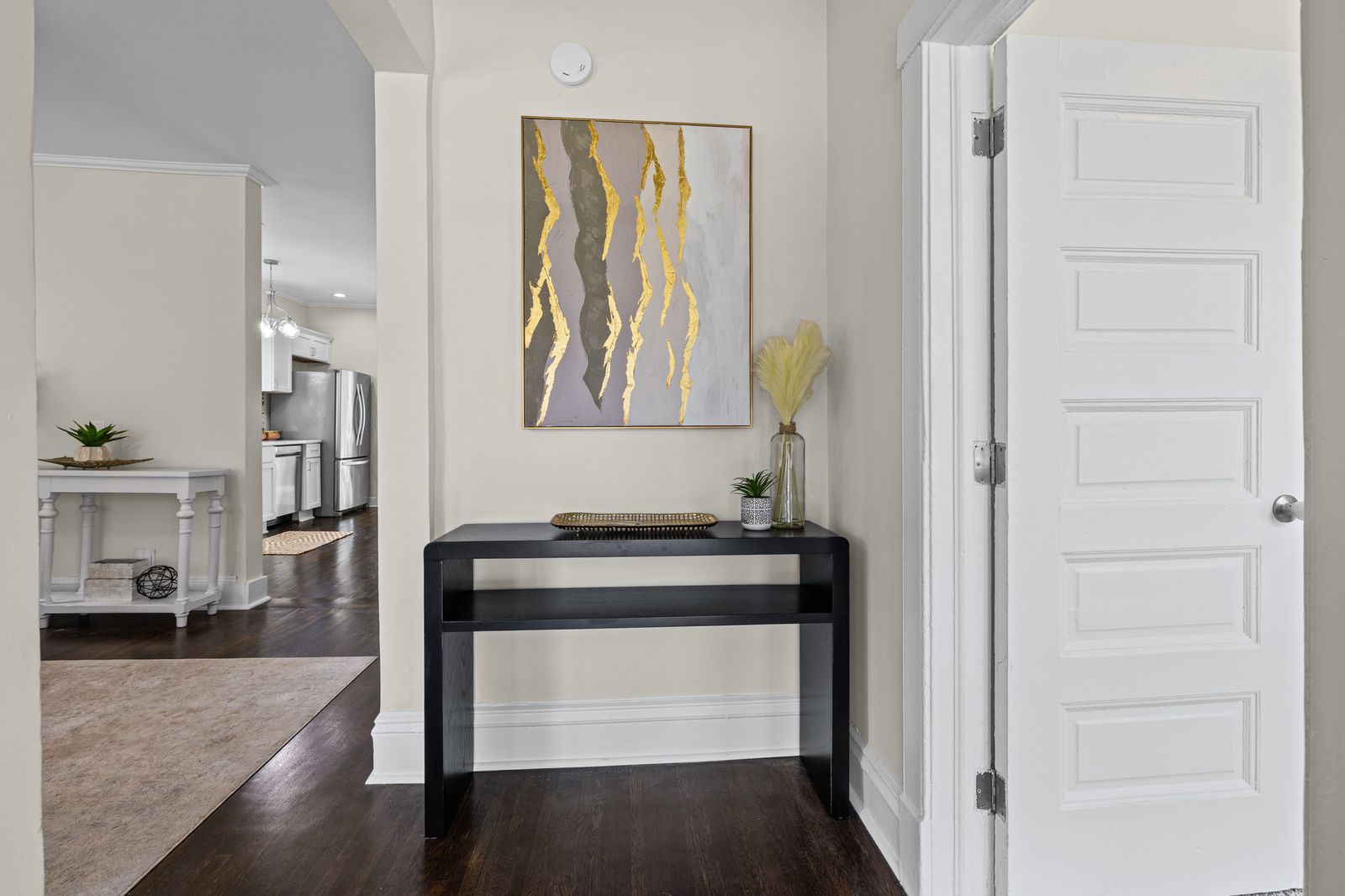 Entry foyer with staged console table and artwork