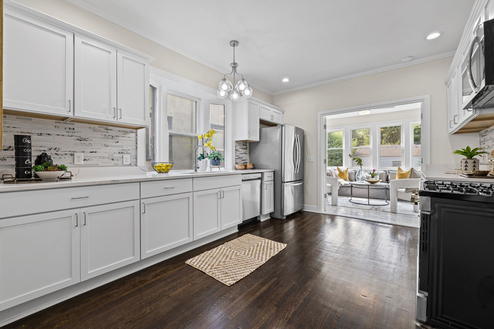 Kitchen with white cabinets and stainless steel refrigerator