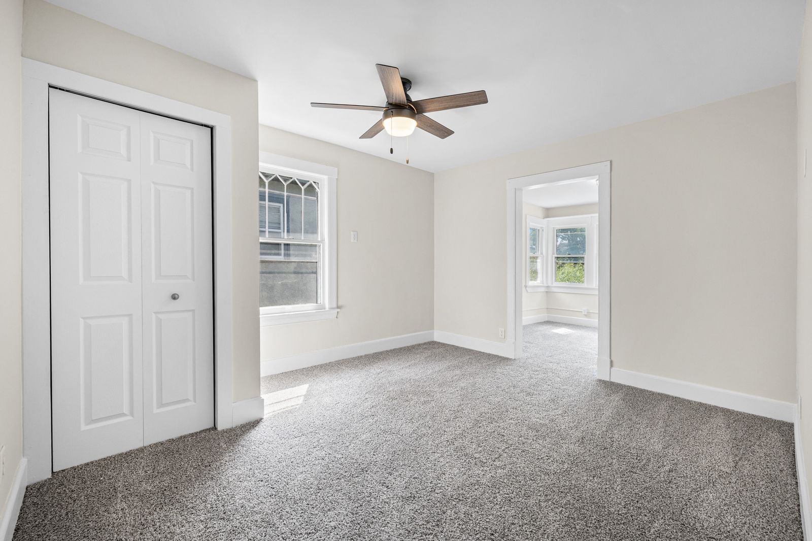 Upstairs bedroom with closet and ceiling fan