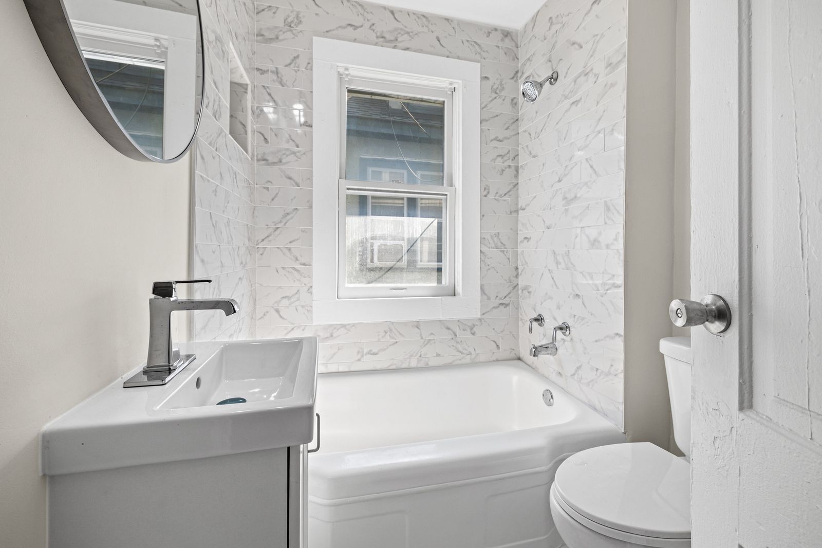 Bathroom with soaking tub and marble surround