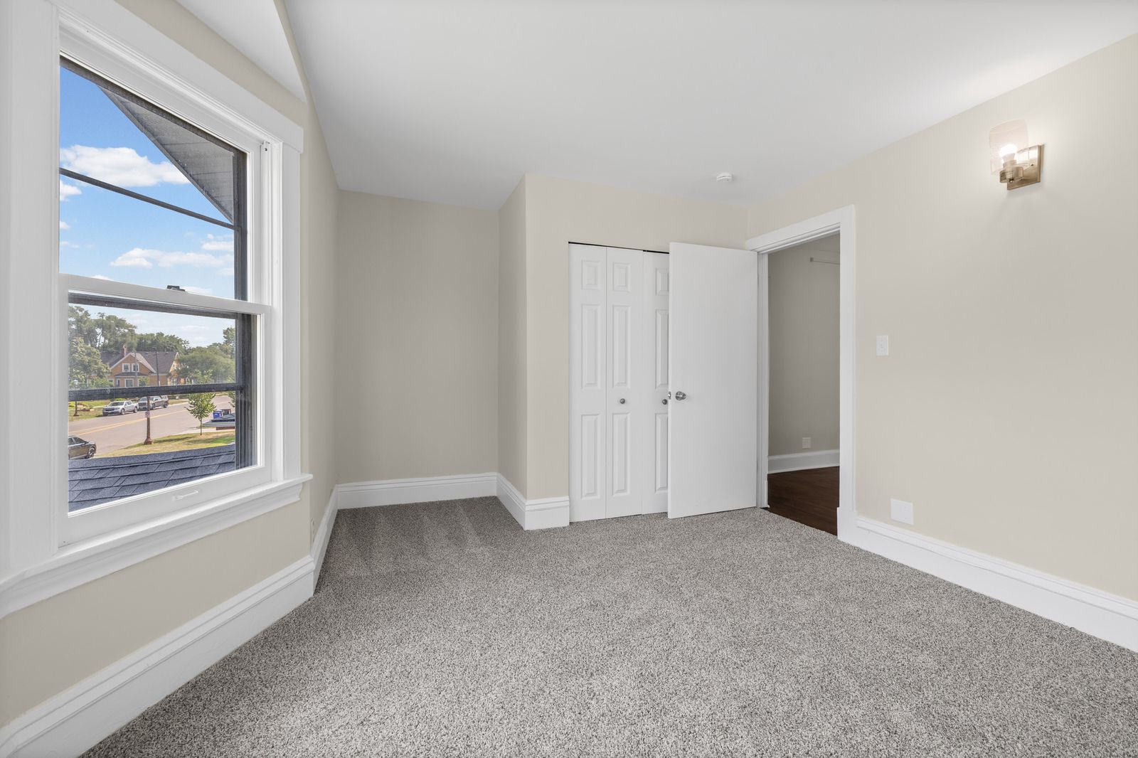 Upstairs bedroom with window and closet