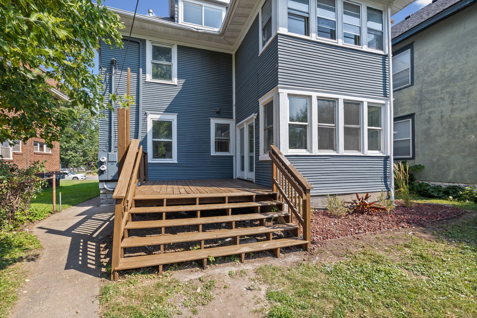 Rear exterior of house with wooden steps to porch