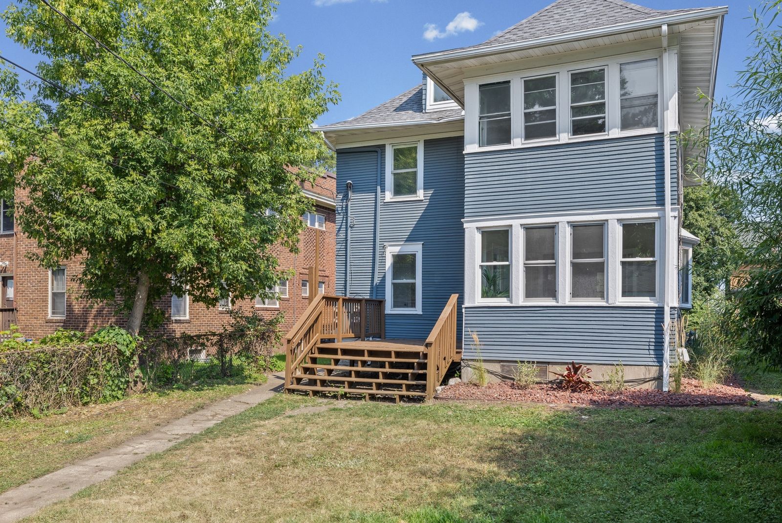 Front exterior of blue two-story house with porch